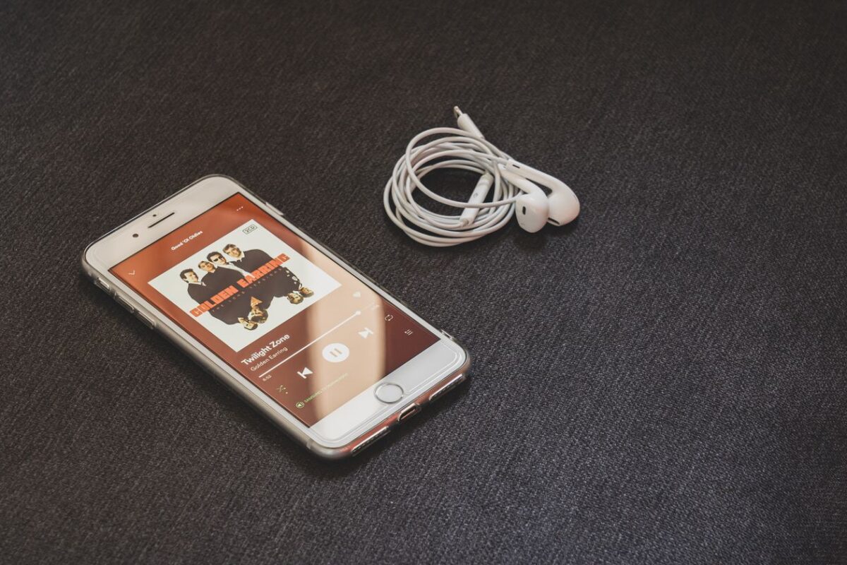 Athlete lifting weights in a gym with an energetic workout playlist on their phone