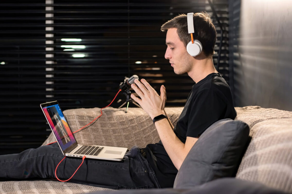 Independent musician celebrating their first 1,000 Spotify streams on a laptop