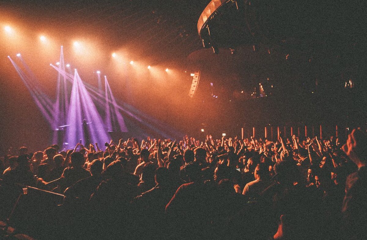 Independent musician connecting with a growing crowd of fans at a small show