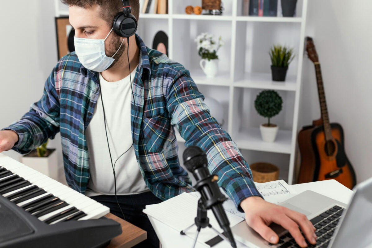 Musician writing a pitch email to a music blog and playlist curator on a laptop