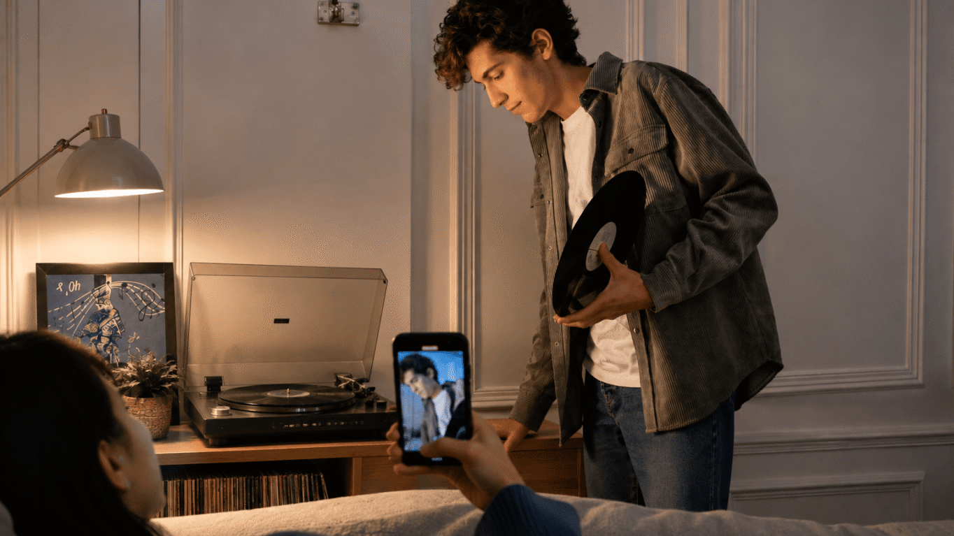Vinyl records and a smartphone side by side, representing analog and digital music culture colliding in 2026