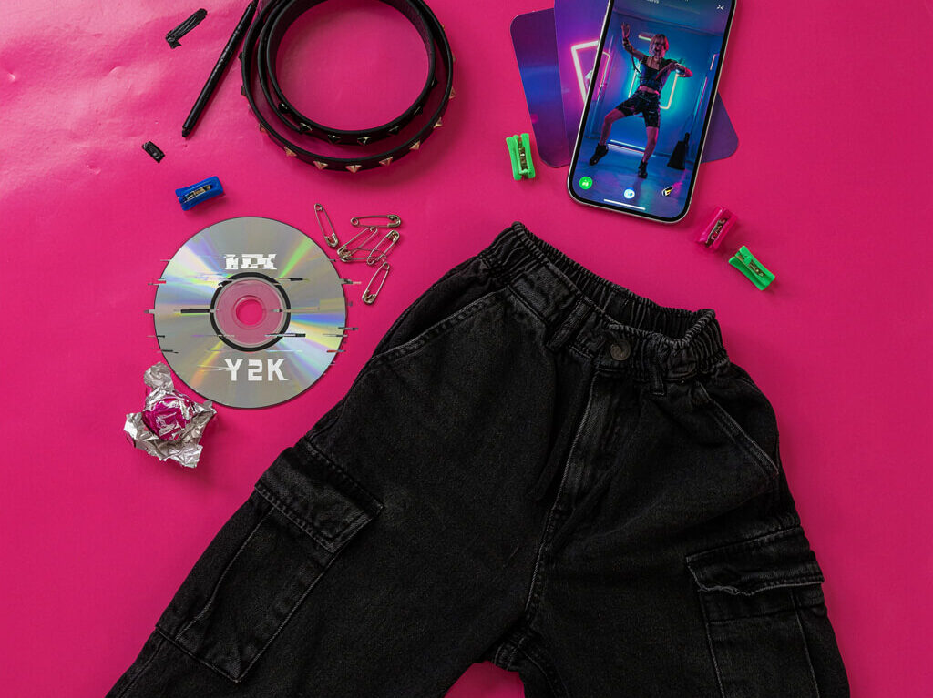 Flat lay of emo, Y2K, and hyperpop fashion and music items representing 2026 subculture revivals